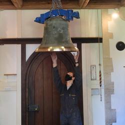 Raising the bell to the ringing platform.