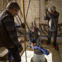 Keith Thomas, Nick Powell and Lawrence White raise the bell to the belfry. Photo: Nigel Francis